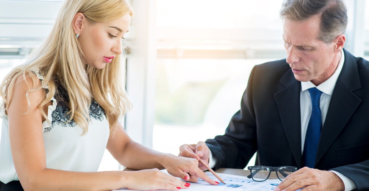 Woman reviewing documents with professional man 1200x628 1